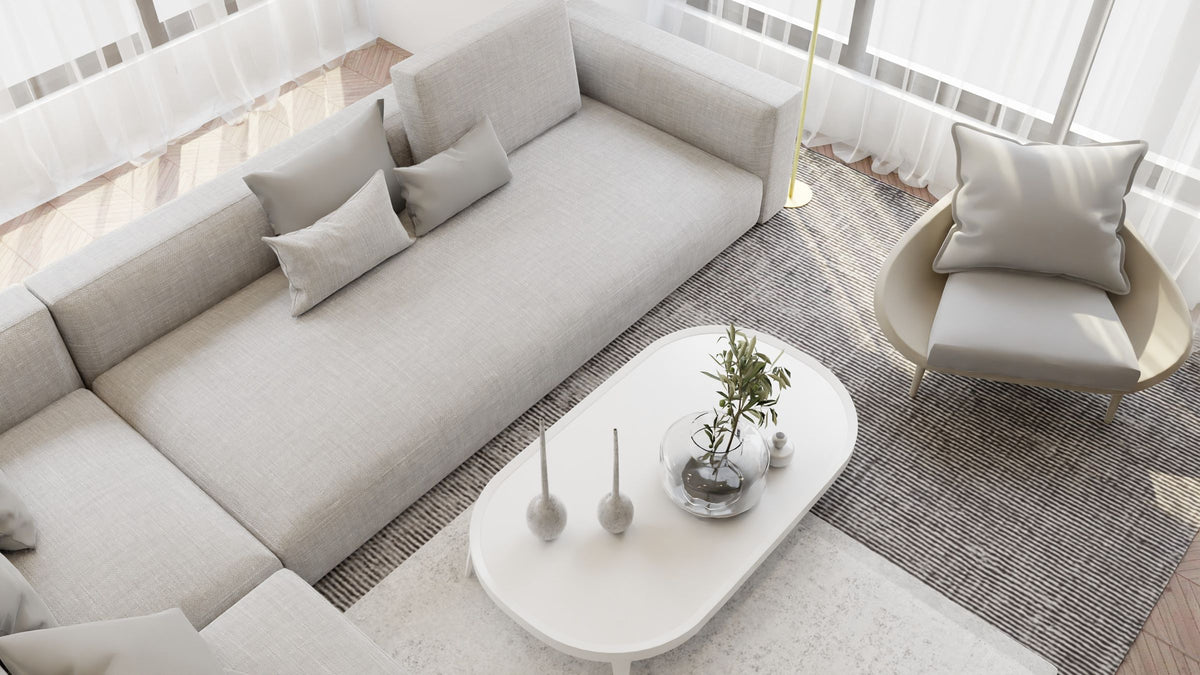 Calm, warm living room with neutral cushions and soft daylight